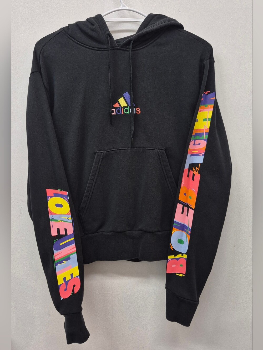 Black Adidas Pride hoodie featuring rainbow-colored "Love Unites" 2XS/2TP